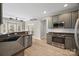 Kitchen featuring stainless steel appliances and gray cabinets, leading to living room at 10933 Sedgemoor E Ln, Charlotte, NC 28277