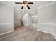 Spacious living room showcasing hardwood floors, a ceiling fan, and a staircase, creating an inviting atmosphere at 10933 Sedgemoor E Ln, Charlotte, NC 28277