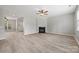Open-concept living room featuring hardwood floors, a fireplace, and seamless flow to other living spaces at 10933 Sedgemoor E Ln, Charlotte, NC 28277