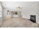Inviting living area with hardwood floors, fireplace, and open layout, seamlessly connecting to the kitchen and dining spaces at 10933 Sedgemoor E Ln, Charlotte, NC 28277