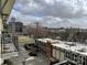 Balcony view of a building, parking lot and the surrounding city skyline at 1101 W 1St St # 410, Charlotte, NC 28202