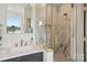 Modern bathroom featuring marble shower, gold fixtures, and a sink with vanity; natural light from the window at 1210 Skyview Rd, Charlotte, NC 28208