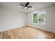 Bedroom featuring hardwood floors, a ceiling fan, and a window overlooking the neighborhood at 1210 Skyview Rd, Charlotte, NC 28208