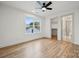 Bright bedroom featuring hardwood floors, a ceiling fan, and a large window at 1210 Skyview Rd, Charlotte, NC 28208