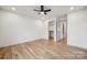 Bright bedroom featuring hardwood floors and access to a walk-in closet and en-suite bathroom at 1210 Skyview Rd, Charlotte, NC 28208