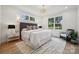 Bright bedroom with a large bed, white walls, two windows, and stylish decor for a comfortable living space at 1210 Skyview Rd, Charlotte, NC 28208