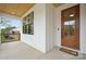 Inviting front porch features a wood ceiling, large window and a glass paneled front door at 1210 Skyview Rd, Charlotte, NC 28208