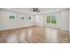 Bright open living room with hardwood floors, large windows, and ceiling fan creating a spacious and welcoming atmosphere at 1210 Skyview Rd, Charlotte, NC 28208