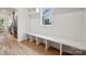 Clean, minimalist mud room with ample bench seating and natural light at 1210 Skyview Rd, Charlotte, NC 28208