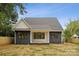 Rear exterior showing a charming home with gray siding and a covered patio area at 1210 Skyview Rd, Charlotte, NC 28208