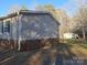 Home's exterior with brick foundation, lawn, vinyl siding, and additional storage building at 1245 Forest Ridge Rd, Bessemer City, NC 28016