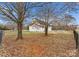Large fenced backyard featuring mature trees, firepit area and patio for outdoor enjoyment and privacy at 134 Falling Leaf Ln, Statesville, NC 28677