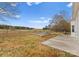 Expansive backyard with a concrete patio and a well defined firepit area surrounded by a black fence at 134 Falling Leaf Ln, Statesville, NC 28677