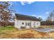 View of the back of the home with patio, table and chairs and a nice firepit area at 134 Falling Leaf Ln, Statesville, NC 28677