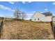 Vast backyard with a shed, wood pile and fenced perimeter offering space to enjoy at 134 Falling Leaf Ln, Statesville, NC 28677