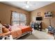 Bedroom features a window, a bed and a desk with shelves at 134 Falling Leaf Ln, Statesville, NC 28677