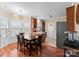 Elegant dining area with modern chandelier, bay window, and seamless flow to the kitchen at 134 Falling Leaf Ln, Statesville, NC 28677