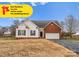 Charming single-story home with a mix of white vinyl siding and brick, plus an attached two-car garage at 134 Falling Leaf Ln, Statesville, NC 28677