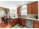 Well-lit kitchen featuring stainless steel appliances, ample countertops, and seamless flow to the dining area at 134 Falling Leaf Ln, Statesville, NC 28677