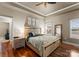 A main bedroom showcasing a tray ceiling, stylish decor and hardwood floors at 134 Falling Leaf Ln, Statesville, NC 28677
