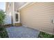 Small stone patio off back of house with steps up to door, side of house with plants at 13925 Helen Benson Blvd, Davidson, NC 28036