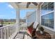 Inviting covered balcony featuring a chair and offering views of the neighborhood and street at 13925 Helen Benson Blvd, Davidson, NC 28036