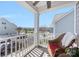 Inviting covered balcony featuring a chair and offering views of the neighborhood and street at 13925 Helen Benson Blvd, Davidson, NC 28036
