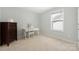 Bright bedroom with neutral walls and carpet, including a desk and dresser set at 13925 Helen Benson Blvd, Davidson, NC 28036