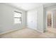 Clean, bright bedroom with neutral walls, carpet, and a window for plenty of natural light at 13925 Helen Benson Blvd, Davidson, NC 28036
