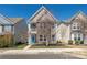 Charming two-story home featuring a stone facade, a blue front door, and a small balcony at 13925 Helen Benson Blvd, Davidson, NC 28036