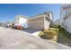 Detached single-car garage with neutral siding and updated landscaping around a sunny driveway at 13925 Helen Benson Blvd, Davidson, NC 28036