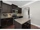 Well-equipped kitchen with granite countertops, dark cabinets, and stainless steel appliances at 13925 Helen Benson Blvd, Davidson, NC 28036