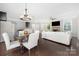 Open-concept living and dining area with hardwood floors and plenty of natural light at 13925 Helen Benson Blvd, Davidson, NC 28036