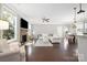 Open living area with stone fireplace, hardwood floors, and cozy white sofa at 13925 Helen Benson Blvd, Davidson, NC 28036