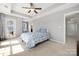 Bright main bedroom featuring tray ceiling, large windows, and carpeted floors at 13925 Helen Benson Blvd, Davidson, NC 28036