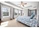 Main bedroom featuring tray ceiling, large windows, and plush carpet at 13925 Helen Benson Blvd, Davidson, NC 28036