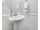 Bright powder room with white pedestal sink and wainscoting at 13925 Helen Benson Blvd, Davidson, NC 28036