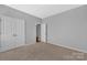 Neutral bedroom with carpet and white closet doors offers a serene and inviting space at 141 Planters Dr, Statesville, NC 28677