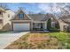 Charming home featuring stone accents, manicured landscaping, and a two-car garage at 141 Planters Dr, Statesville, NC 28677