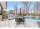 Inviting outdoor space with pool, patio, and outdoor kitchen featuring a built-in grill and dining area at 14130 Sunnyhill Grove Rd, Davidson, NC 28036
