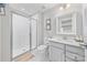 All-white bathroom boasts a glass enclosed shower, a modern vanity, and clean, elegant lines at 14130 Sunnyhill Grove Rd, Davidson, NC 28036