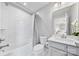 Bright bathroom features a shower-over-tub and a single sink vanity at 14130 Sunnyhill Grove Rd, Davidson, NC 28036