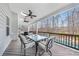This covered deck offers outdoor dining, ceiling fans, and a view of the backyard pool at 14130 Sunnyhill Grove Rd, Davidson, NC 28036