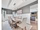 Elegant dining room features a long table, upholstered chairs, wainscoting, and modern lighting at 14130 Sunnyhill Grove Rd, Davidson, NC 28036