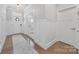 Bright foyer showcases hardwood floors, elegant trim work, and a view to the front door at 14130 Sunnyhill Grove Rd, Davidson, NC 28036