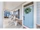 Inviting front porch with rocking chairs, shutters, and a decorative wreath on a blue door at 14130 Sunnyhill Grove Rd, Davidson, NC 28036
