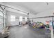 Spacious garage can also be used as a play room, featuring epoxy flooring and abundant space at 14130 Sunnyhill Grove Rd, Davidson, NC 28036