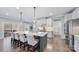 Modern kitchen featuring a large island with seating, stainless appliances, and stylish lighting fixtures at 14130 Sunnyhill Grove Rd, Davidson, NC 28036