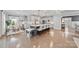 Bright kitchen featuring a large island with seating, white cabinetry, and hardwood floors at 14130 Sunnyhill Grove Rd, Davidson, NC 28036