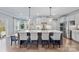 Gourmet kitchen boasts a large island with bar seating, stainless appliances, and pendant lighting at 14130 Sunnyhill Grove Rd, Davidson, NC 28036